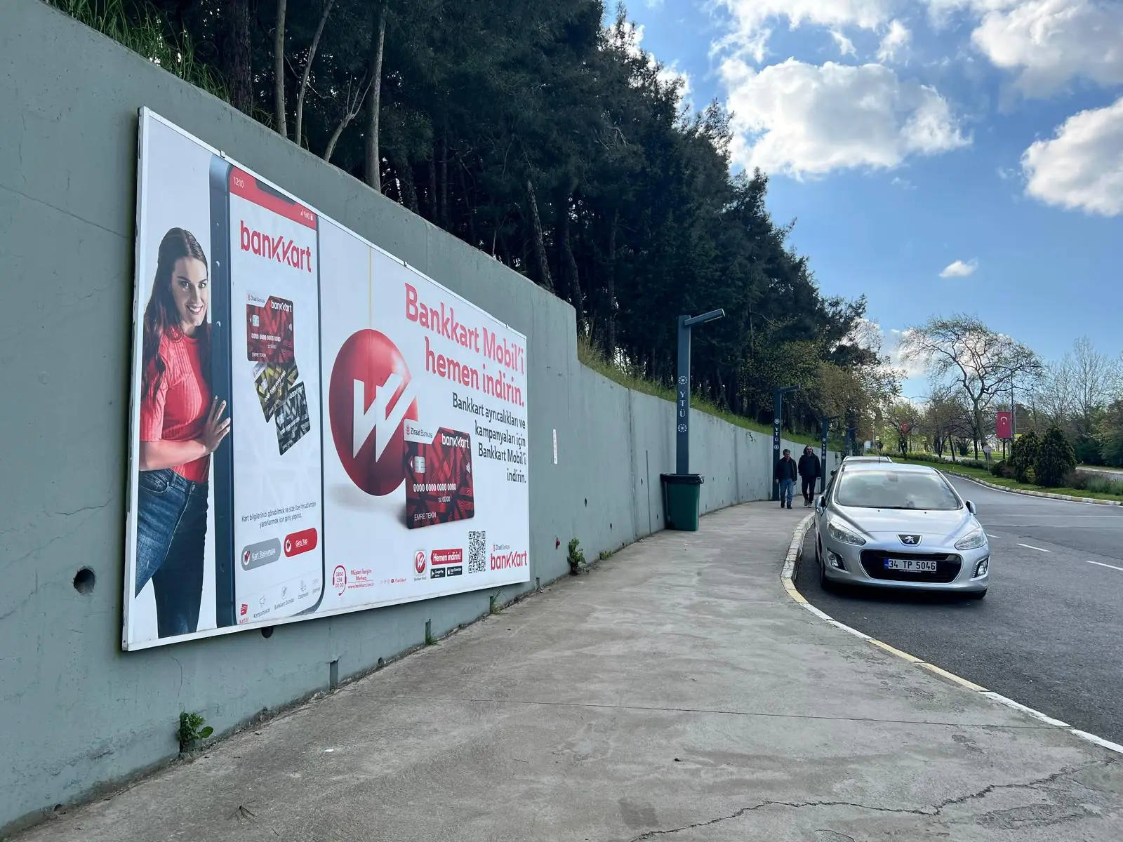 Billboards mounted along a campus wall